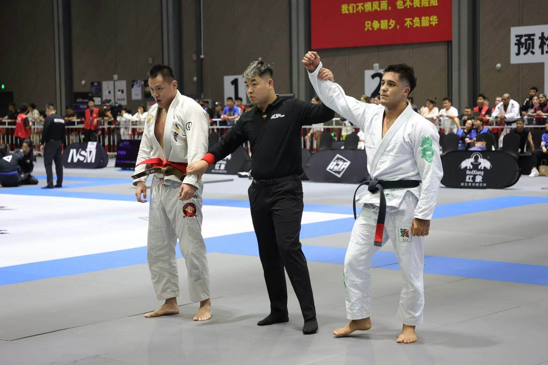 Two Brazilian Jiu-Jitsu competitors await results during a match, highlighting Jiu-Jitsu competition rules.