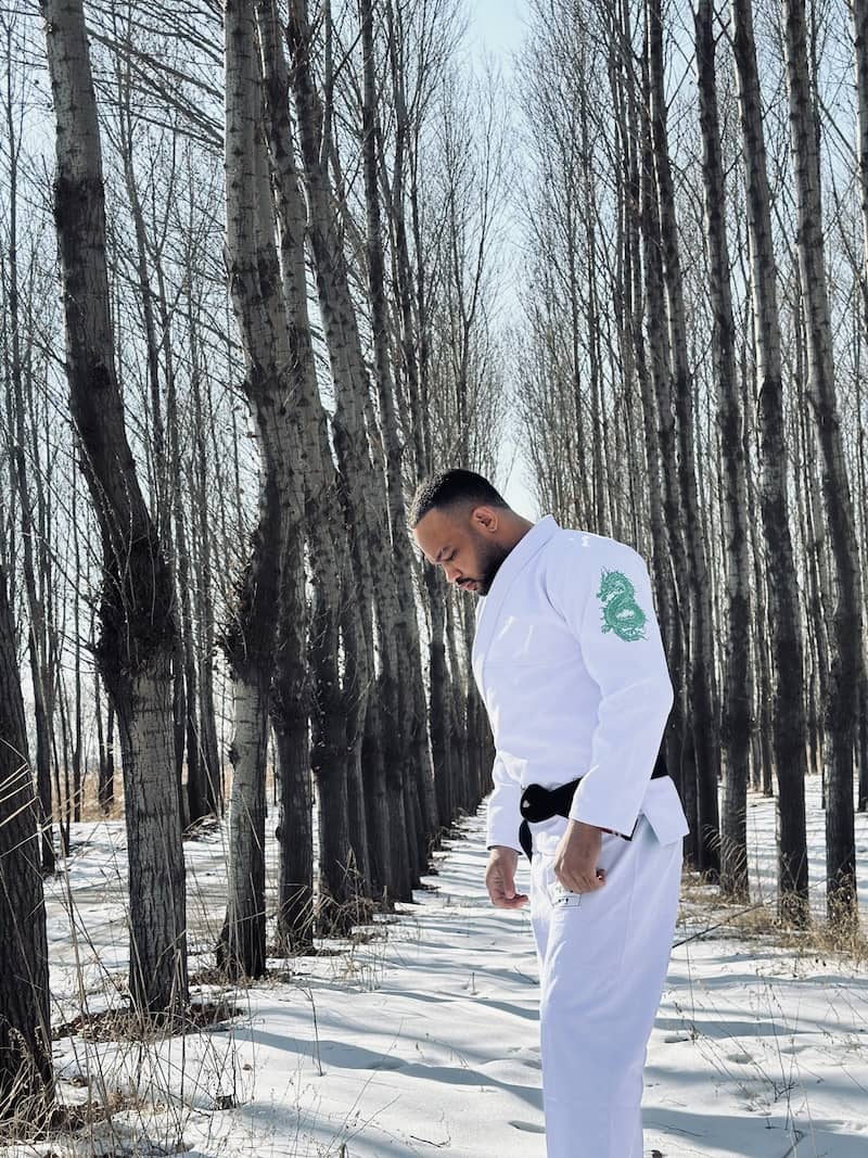 ZHAN Year of the Dragon Limited Edition BJJ Gi worn outdoors in a snowy forest setting.