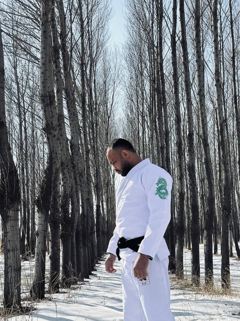 ZHAN Year of the Dragon Limited Edition BJJ Gi modeled in a winter forest, showcasing dragon design and traditional style.