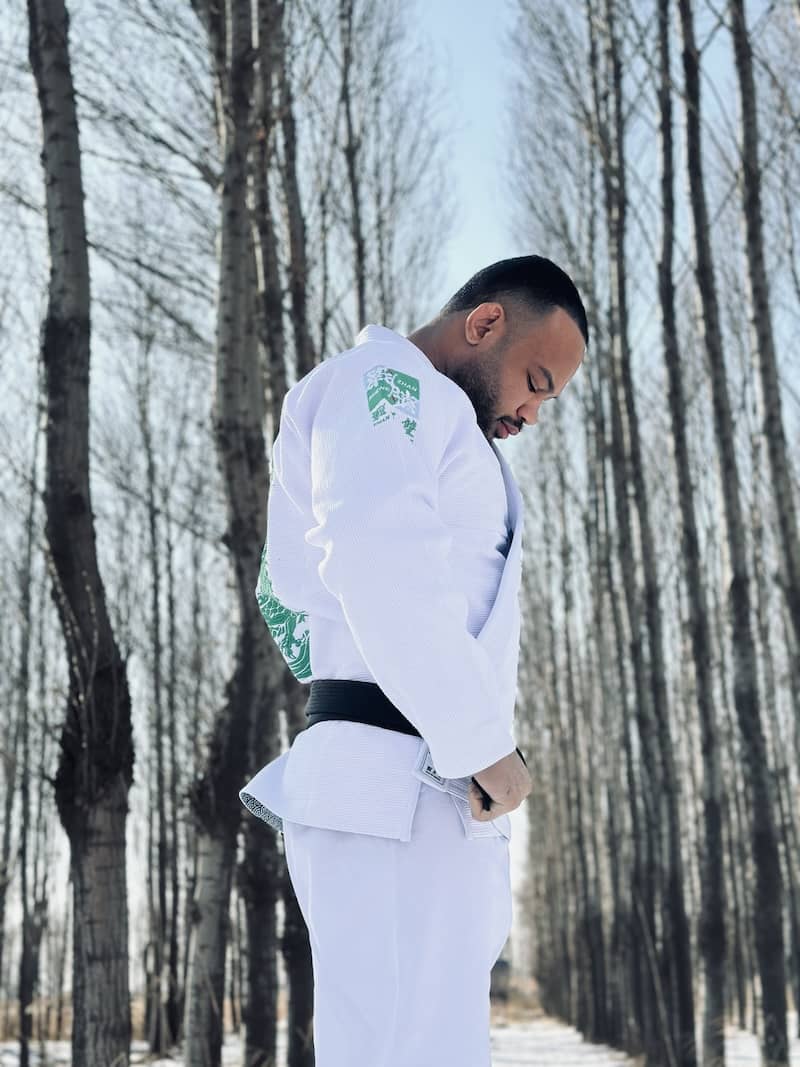 ZHAN Year of the Dragon Limited Edition BJJ Gi worn by a practitioner in a serene outdoor setting.
