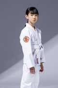 A young girl wearing the BLITZ Kids Super Power BJJ Gi, showcasing comfort and style for Brazilian Jiu-Jitsu training.