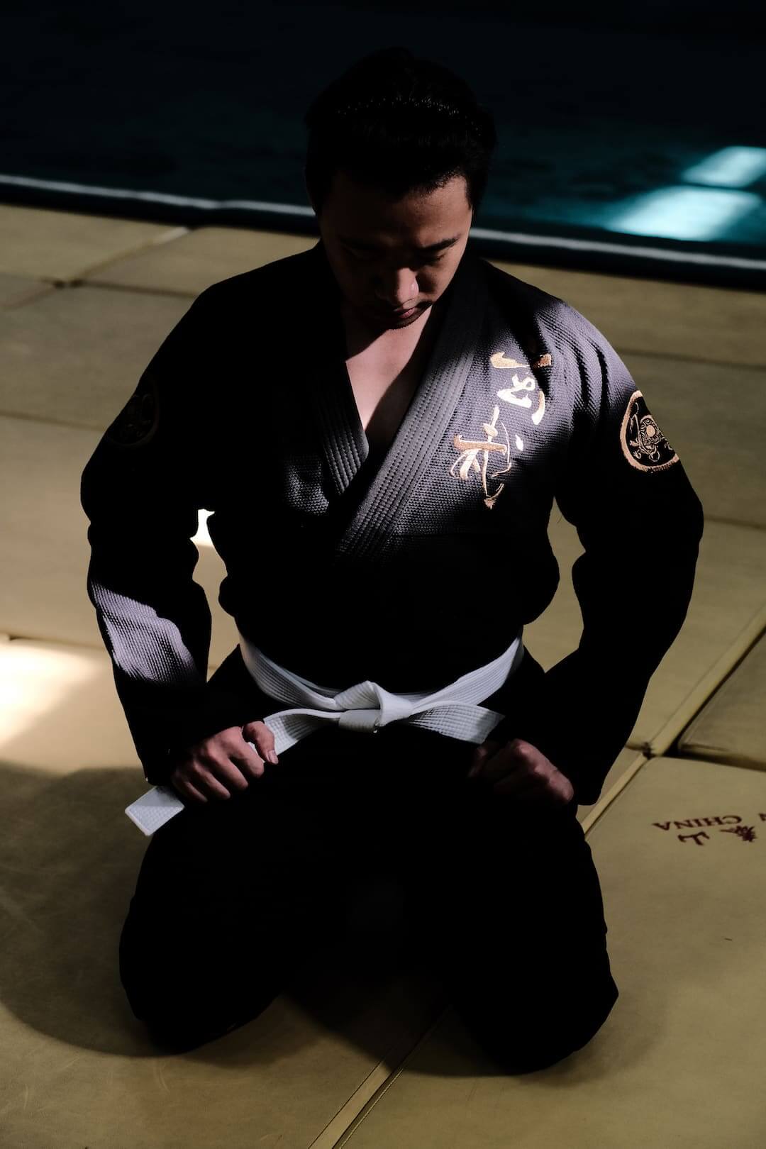ZHAN Black Tortoise BJJ Gi displayed on practitioner in a dojo, showcasing its unique design and details.