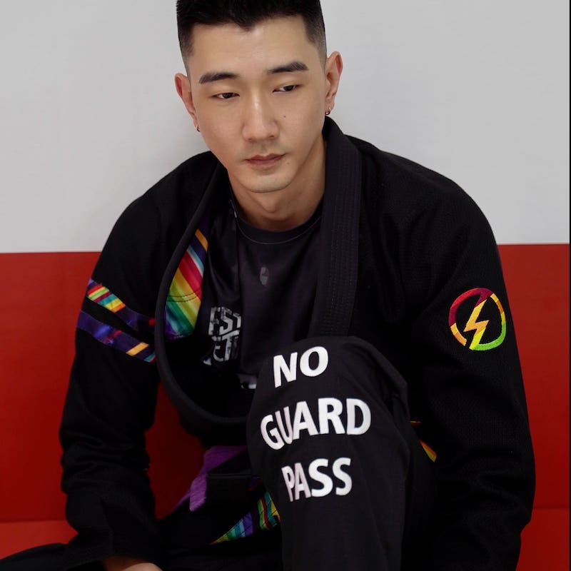 BLITZ DEFENSE Series Rainbow BJJ Set: Durable & Stylish Gi worn by a model showcasing its vibrant design.