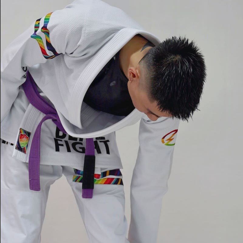 BLITZ DEFENSE Series Rainbow BJJ Set: Durable & Stylish Gi, featuring a practitioner in action with vibrant details.
