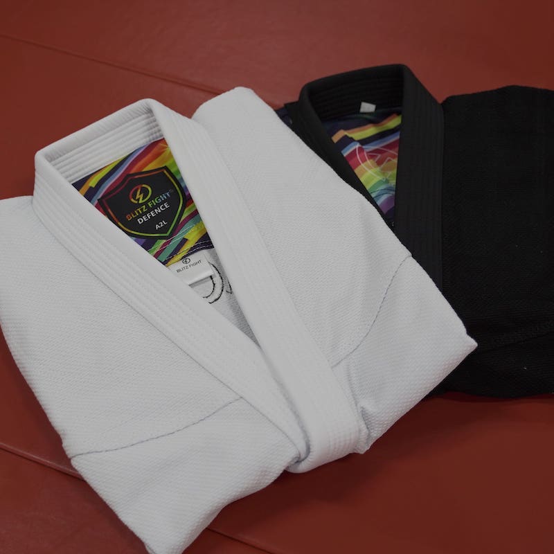 BLITZ DEFENSE Series Rainbow BJJ Set: Durable & Stylish Gi displayed in white and black colors