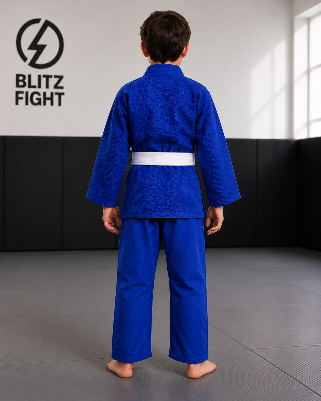 BLITZ Kids Basic BJJ Gi displayed on a young boy in a blue gi, showcasing the back view and BLITZ branding.
