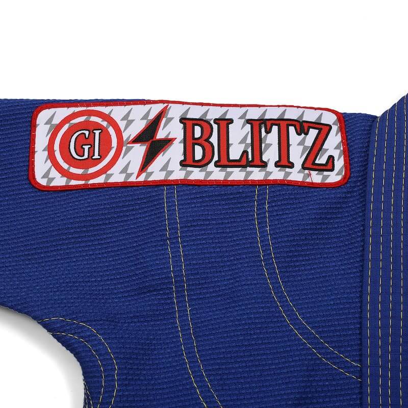 BLITZ Kids Classic BJJ Gi: Tradition & Excellence with embroidered logo detail on blue fabric.