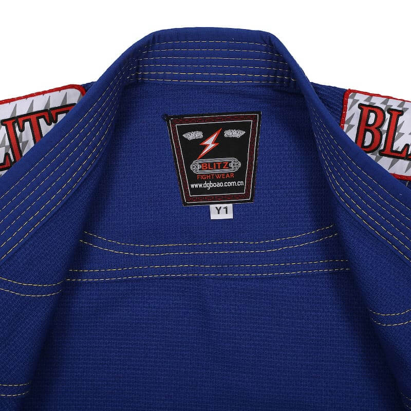 BLITZ Kids Classic BJJ Gi: Tradition & Excellence inner label and stitching details in blue fabric.