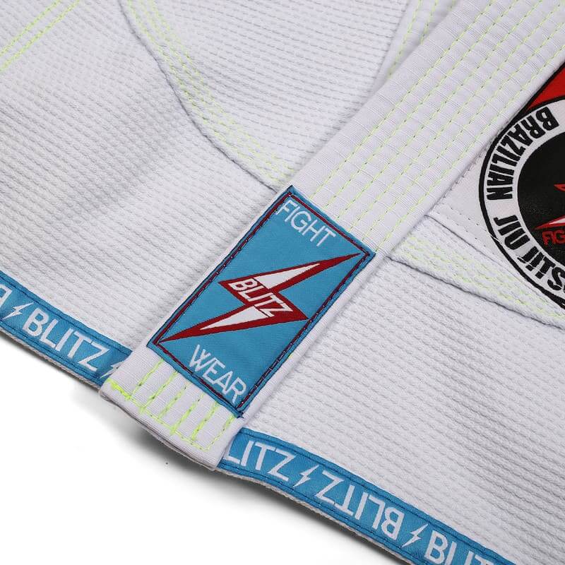 BLITZ Kids Classic BJJ Gi: Tradition & Excellence showcasing the embroidered logo and fight wear label detail.