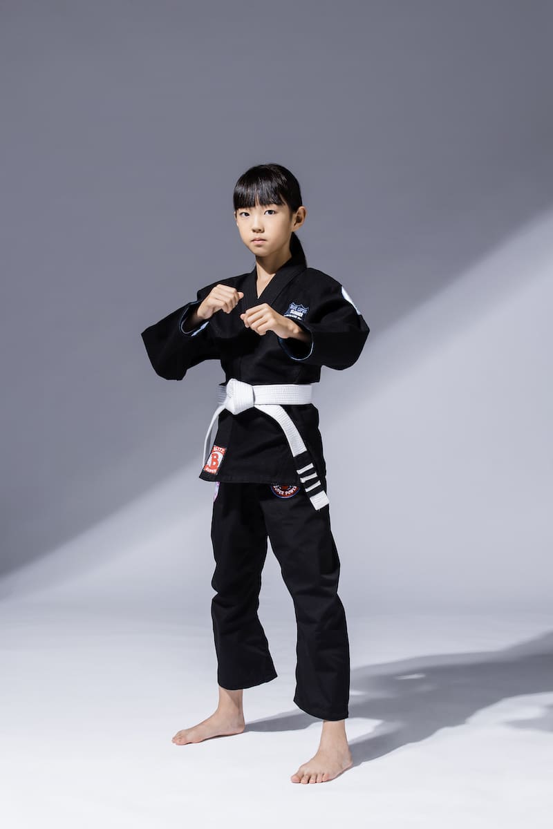 BLITZ Kids Super Power BJJ Gi worn by a young athlete, showcasing a comfortable fit and fun design for kids.