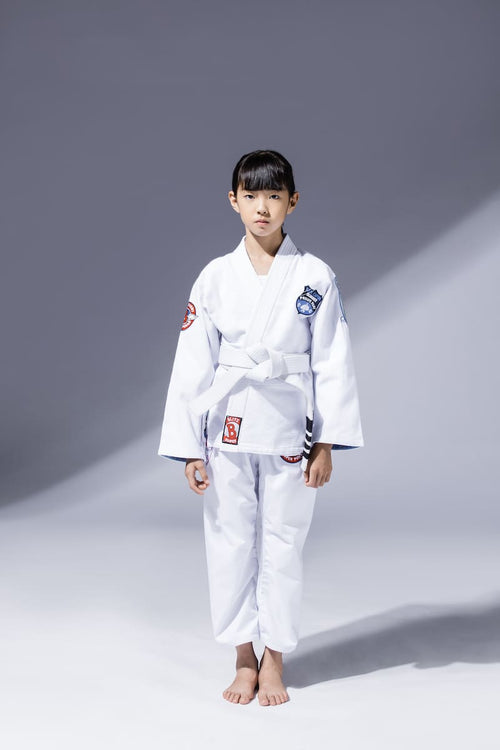 A child wearing a BLITZ Kids Super Power BJJ Gi, showcasing its comfortable and durable design for young athletes.