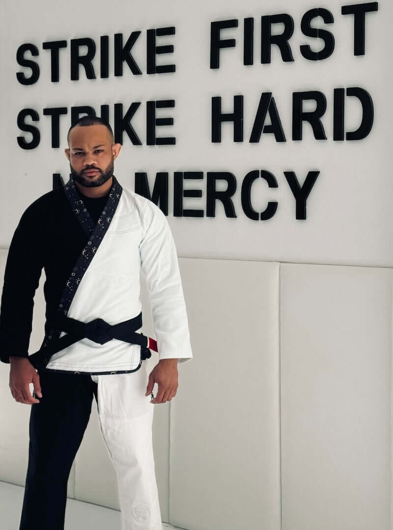 BLITZ Sun & Moon Brazilian Jiu-Jitsu Gi worn by a practitioner in a training space with motivational text.
