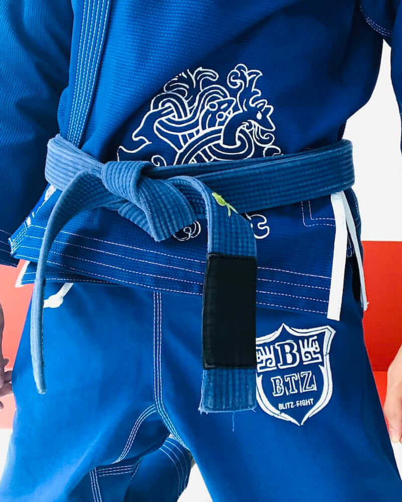 BLITZ Viking God BJJ Gi showcasing Norse-inspired graphics and a blue belt design detail.