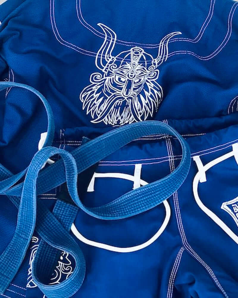 BLITZ Viking God BJJ Gi with Norse-inspired artwork and blue design, featuring intricate embroidery and woven labels.