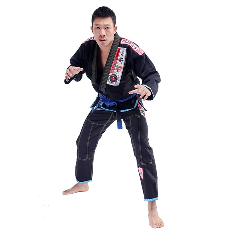 Classic BLITZ BJJ Gi: Embrace Excellence & Tradition worn by a martial artist in a fighting stance.