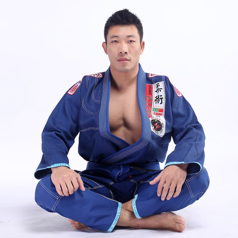 Classic BLITZ BJJ Gi: Embrace Excellence & Tradition, showcasing a practitioner in a blue gi.