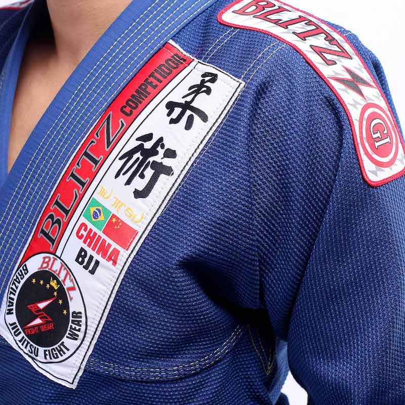 Classic BLITZ BJJ Gi: Embrace Excellence & Tradition featuring vibrant blue fabric and intricate embroidery.