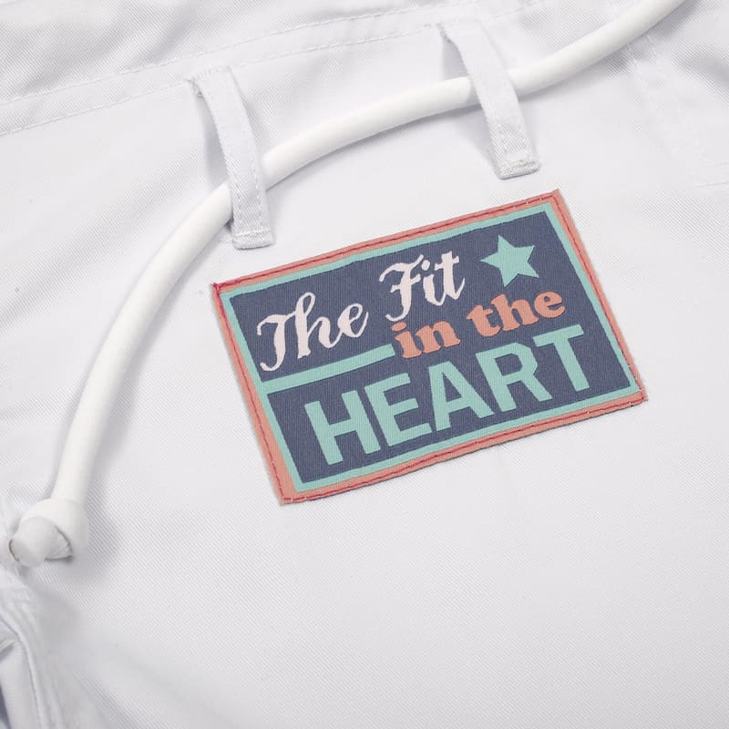 The Fit in the HEART tag on a white garment showing a colorful design and message.