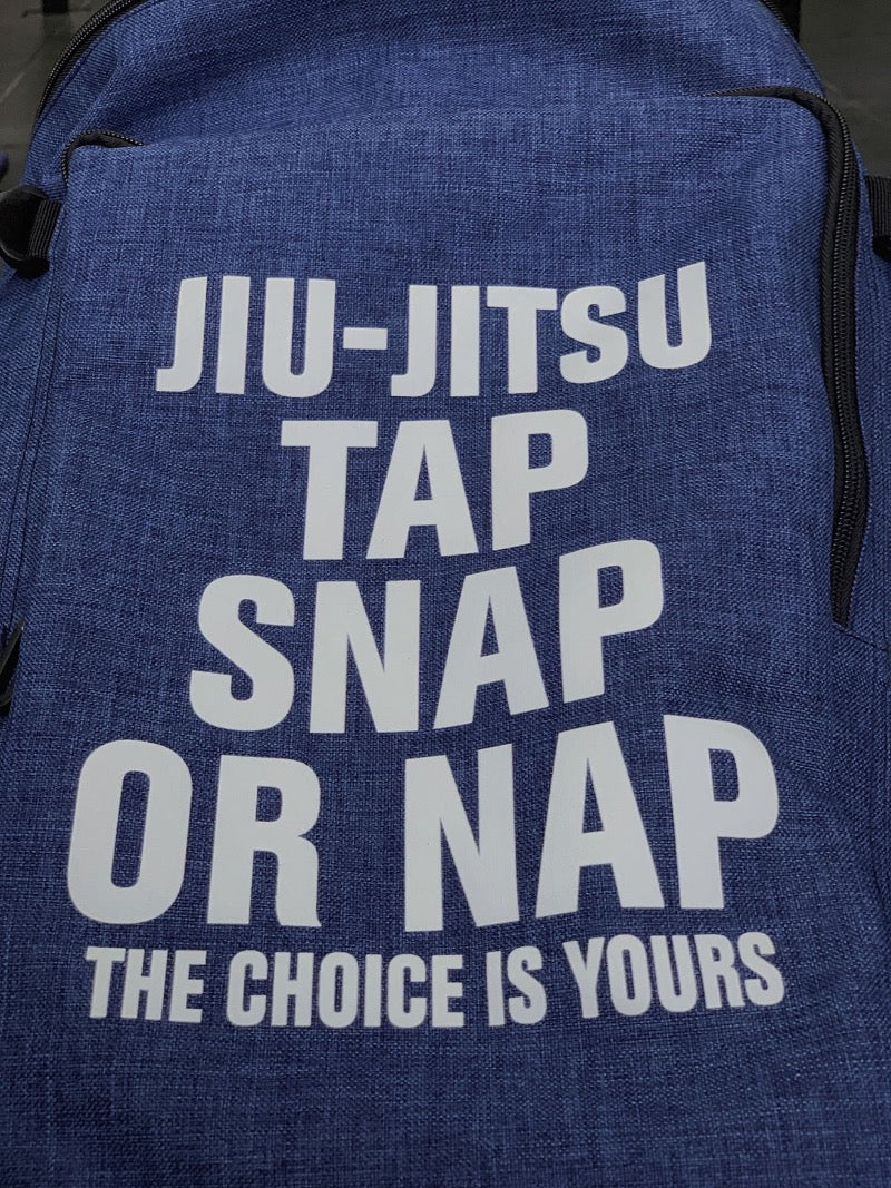 Jiu-Jitsu backpack with text "Tap Snap or Nap The Choice is Yours" on a blue fabric design.