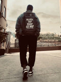 Ultimate BJJ Backpack: Spacious & Durable Gear Bag for Martial Artists worn by a martial artist on the street.