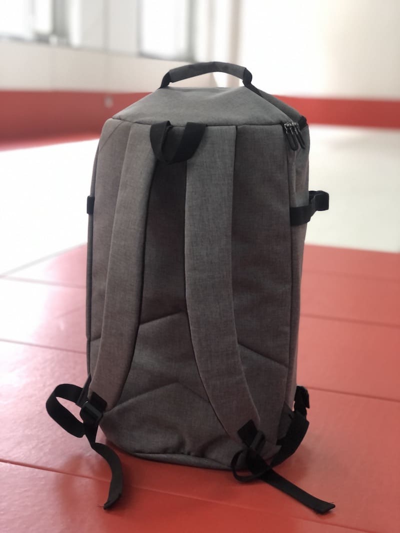 Ultimate BJJ Backpack: Spacious & Durable Gear Bag for Martial Artists on a training mat.