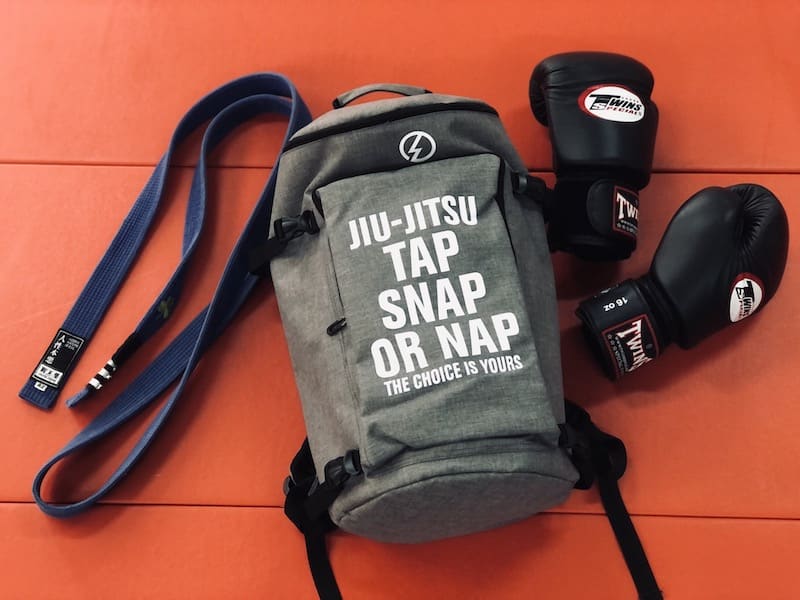 Ultimate BJJ Backpack: Spacious & Durable Gear Bag for Martial Artists with gloves and belt.