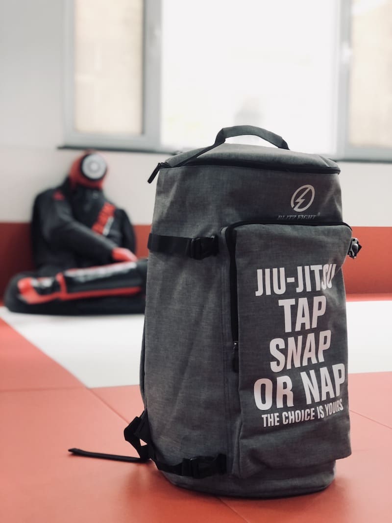 Ultimate BJJ Backpack: Spacious & Durable Gear Bag for Martial Artists on a training mat.