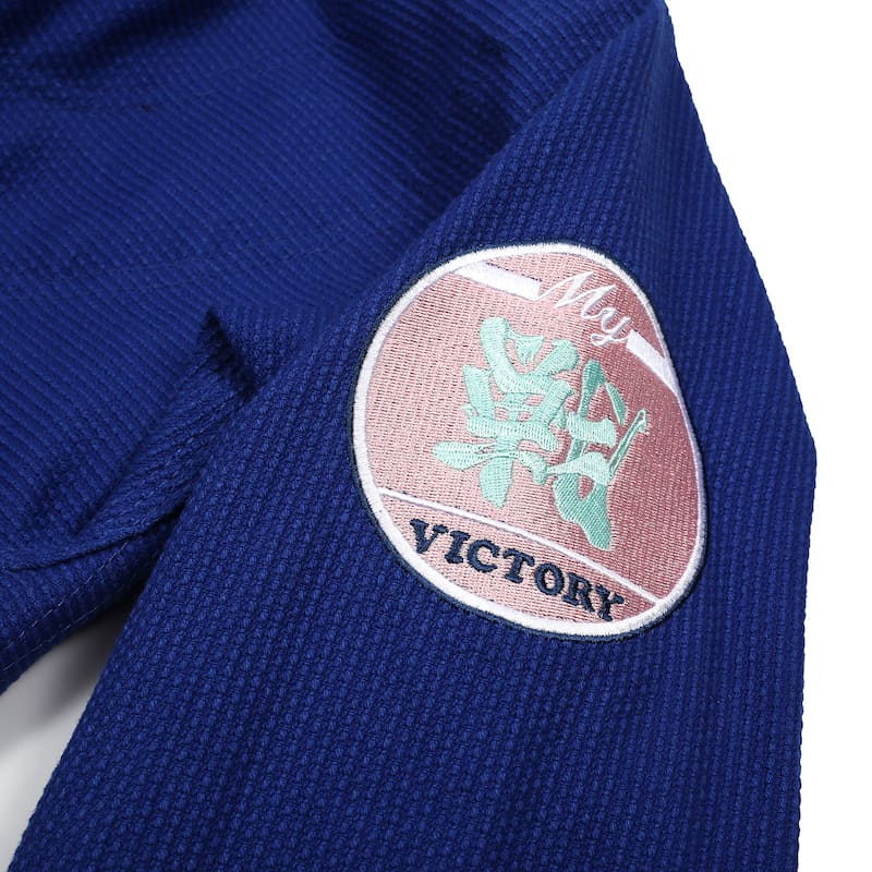 ZHAN Basic Women's BJJ Gi: Embrace Elegance & Performance patch on blue Gi fabric.