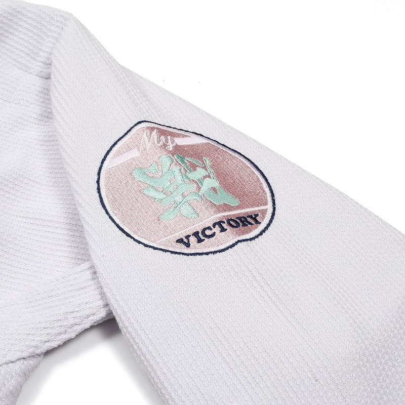 ZHAN Basic Women's BJJ Gi: Embrace Elegance & Performance with minimalistic embroidered logo detail.