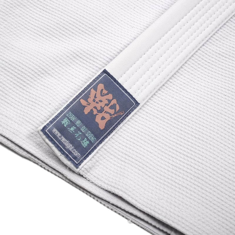 ZHAN Basic Women's BJJ Gi: Embrace Elegance & Performance label detail showcasing quality craftsmanship and minimalistic design.