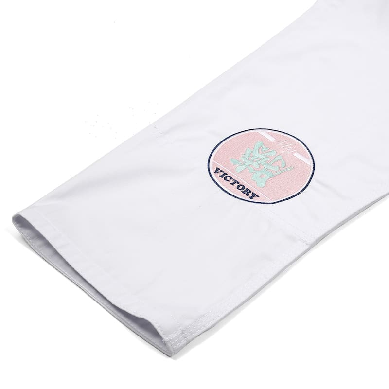 ZHAN Basic Women's BJJ Gi: Embrace Elegance & Performance sleeve detail with embroidered victory patch