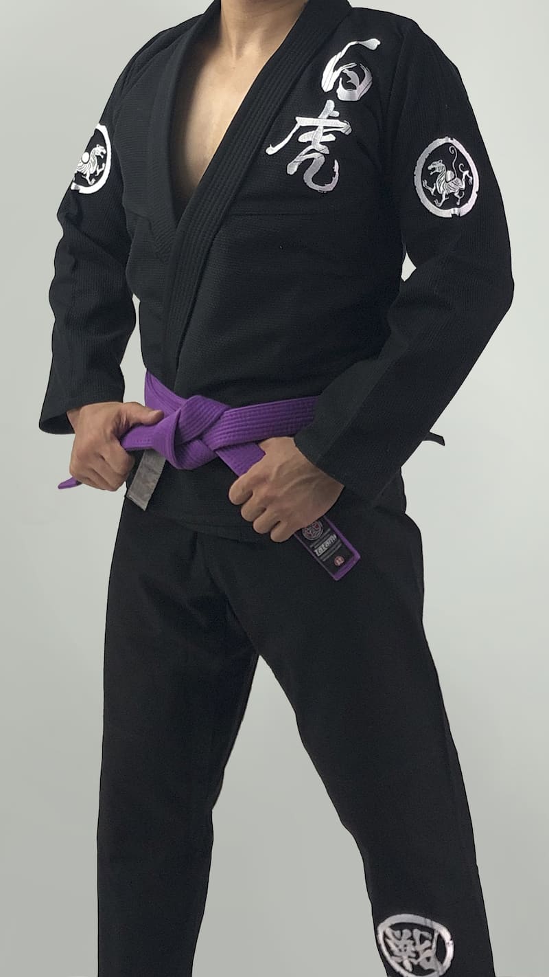 ZHAN White Tiger BJJ Gi worn by a practitioner with a purple belt showcasing intricate detailing and embroidery.