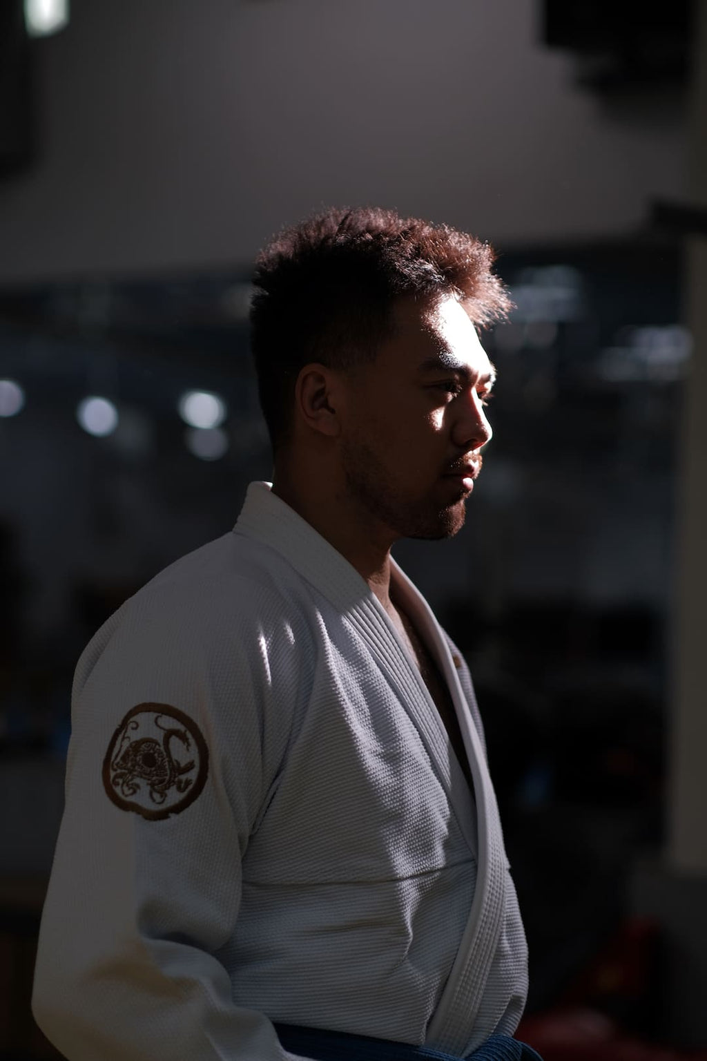 Man wearing ZHAN Black Tortoise BJJ Gi, showcasing the contrasting design and traditional martial arts style.