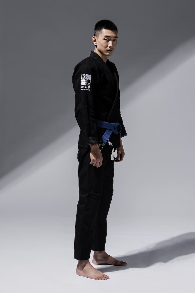 ZHAN Good vs Evil BJJ Gi worn by a model standing in a dramatic pose.
