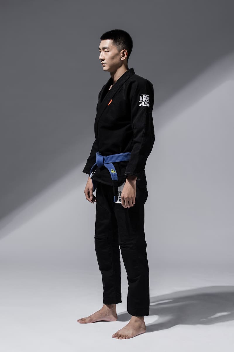 ZHAN Good vs Evil BJJ Gi worn by a practitioner in a black gi with a blue belt.