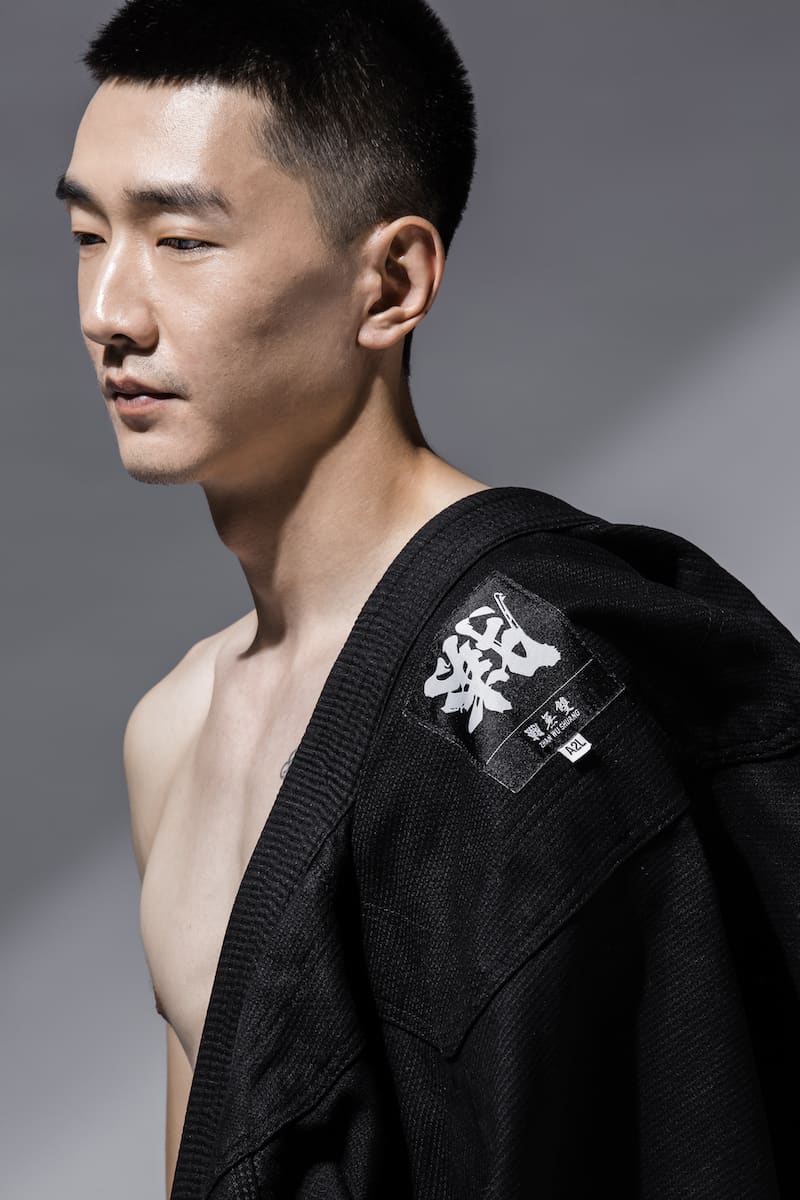 Model showcasing ZHAN Good vs Evil BJJ Gi, emphasizing design and performance traits in Brazilian Jiu-Jitsu.