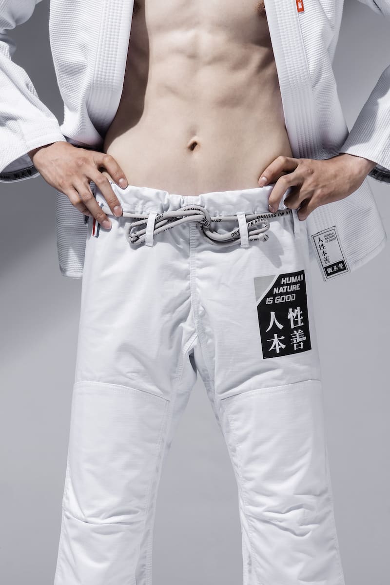ZHAN Good vs Evil BJJ Gi showcasing white pants with graphic design and belt.