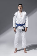 ZHAN Good vs Evil BJJ Gi model wearing blue belt in action pose on gray background.