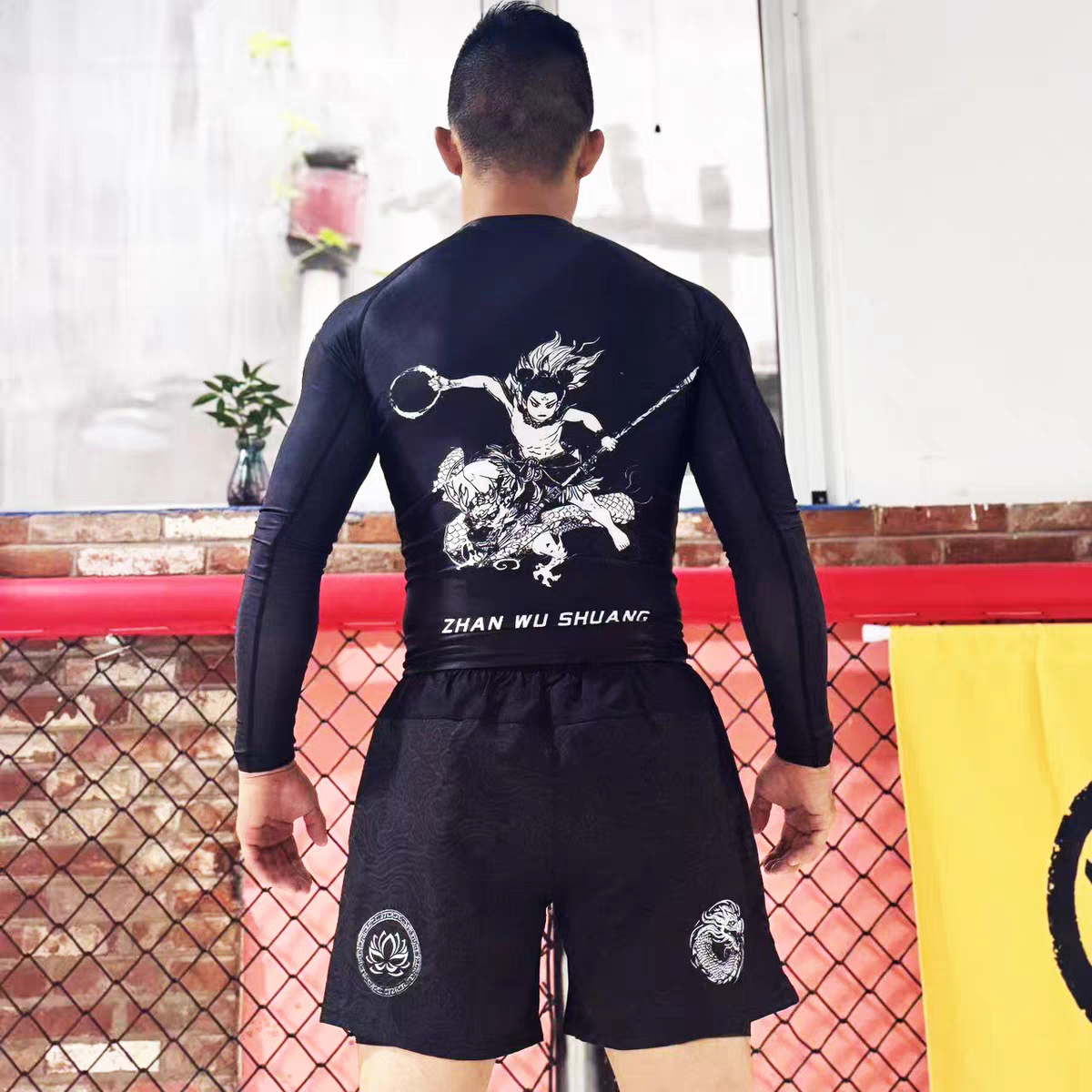 ZHAN Nezha Long Sleeve BJJ Rash Guard & No-Gi Shorts Set worn by a male athlete from behind in a training environment.