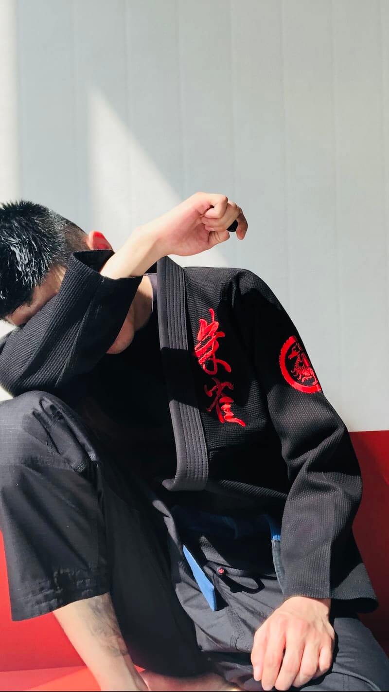 ZHAN Vermilion Phoenix BJJ Gi worn by a practitioner, showcasing intricate embroidery and traditional design.
