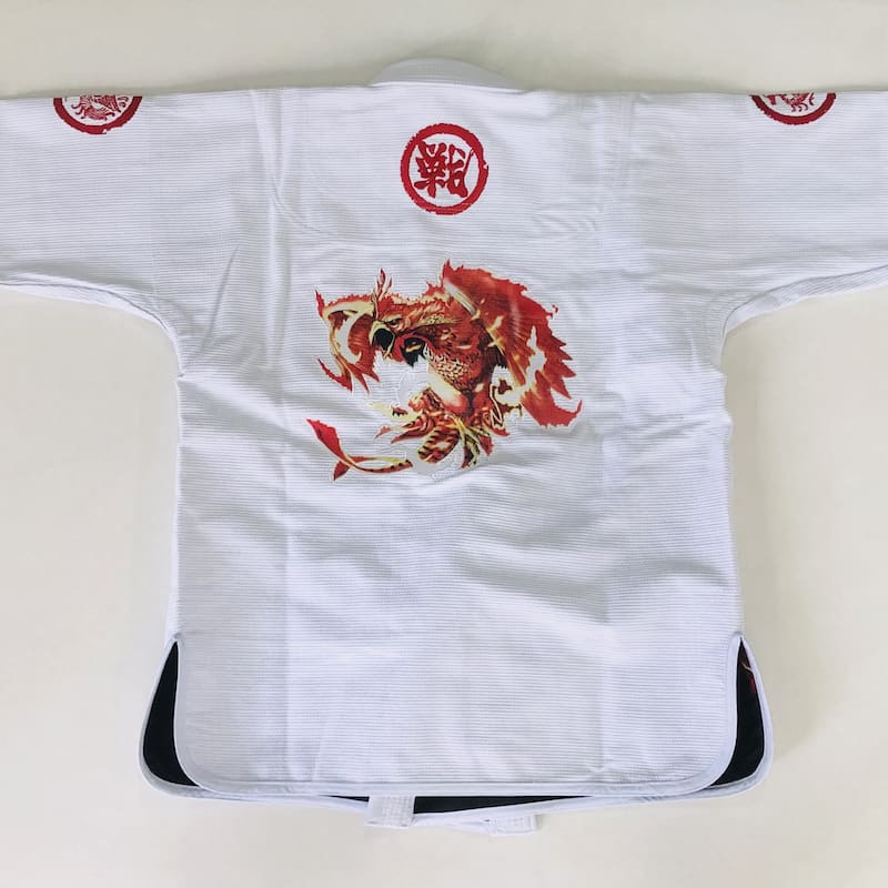 ZHAN Vermilion Phoenix BJJ Gi featuring vibrant phoenix artwork and intricate embroidery on a white fabric.
