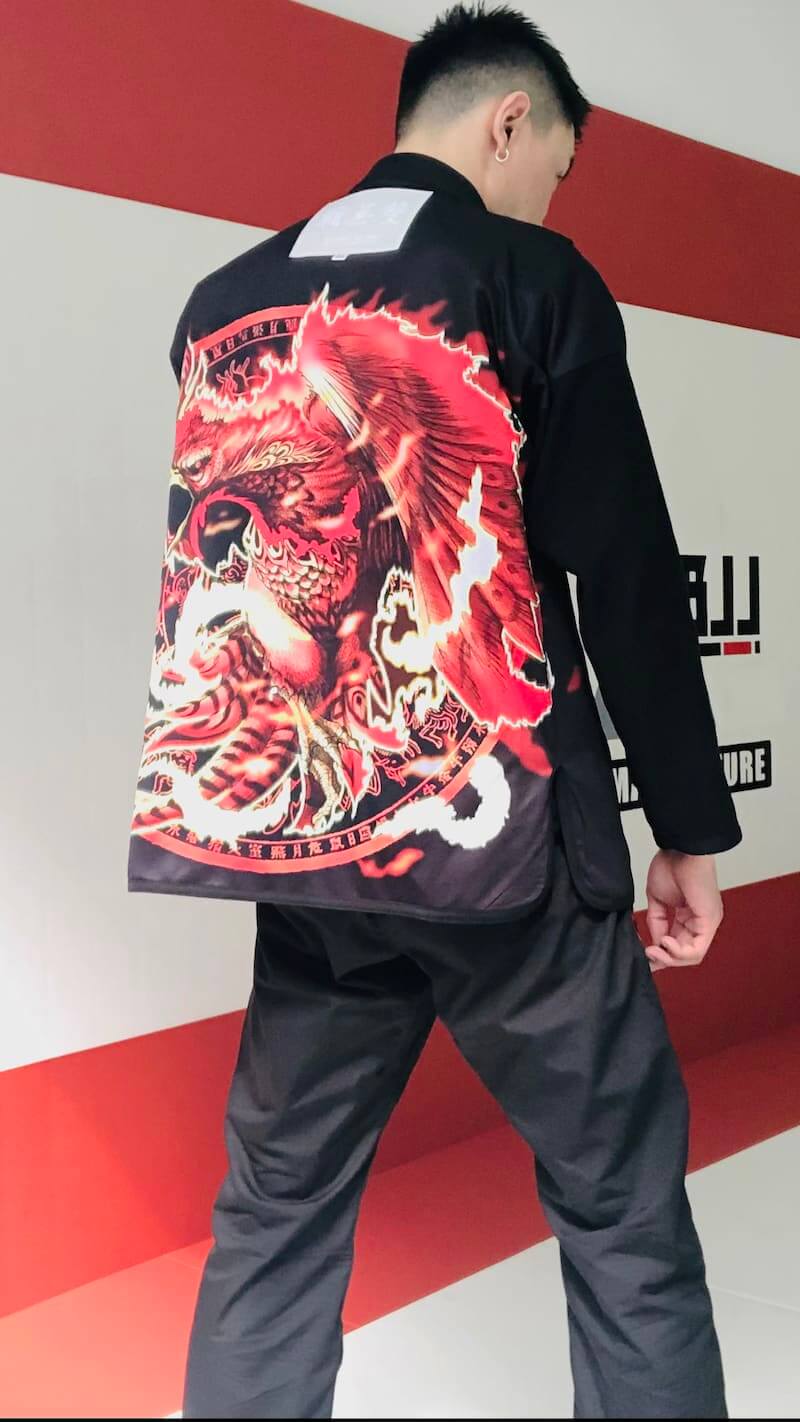 ZHAN Vermilion Phoenix BJJ Gi featuring vibrant phoenix design on the back, showcasing intricate artwork and details.