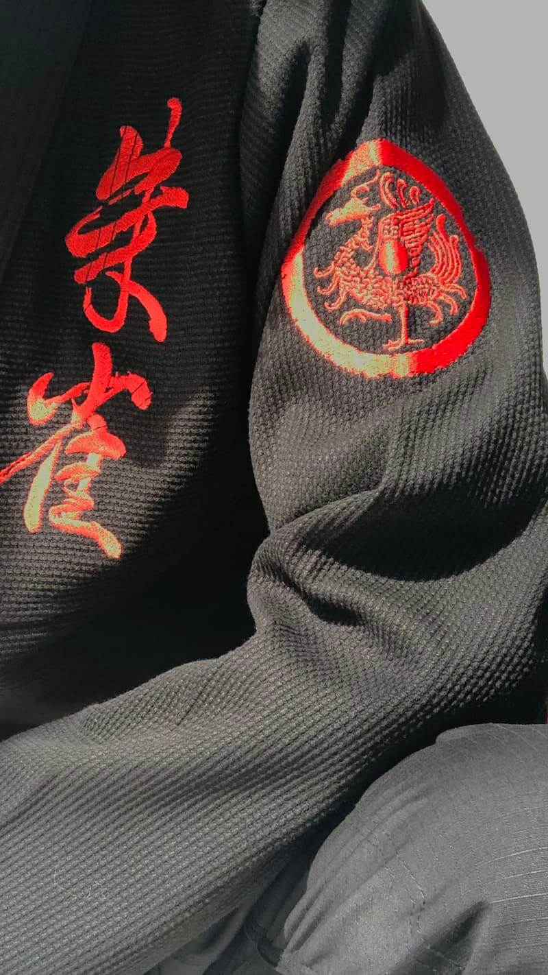 ZHAN Vermilion Phoenix BJJ Gi featuring intricate embroidery and phoenix-themed design on the sleeve.