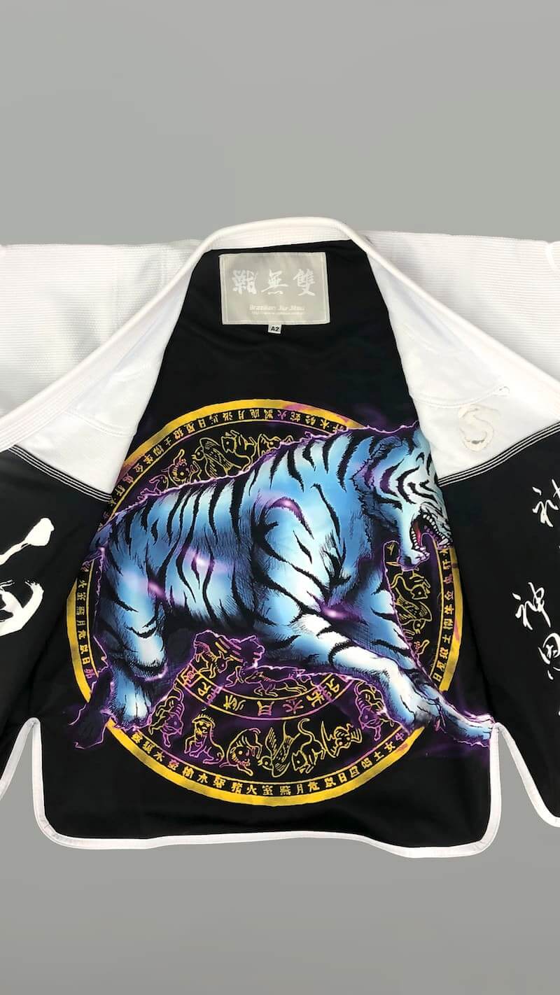 ZHAN White Tiger BJJ Gi featuring vibrant tiger artwork and intricate embroidery on the inner lining.
